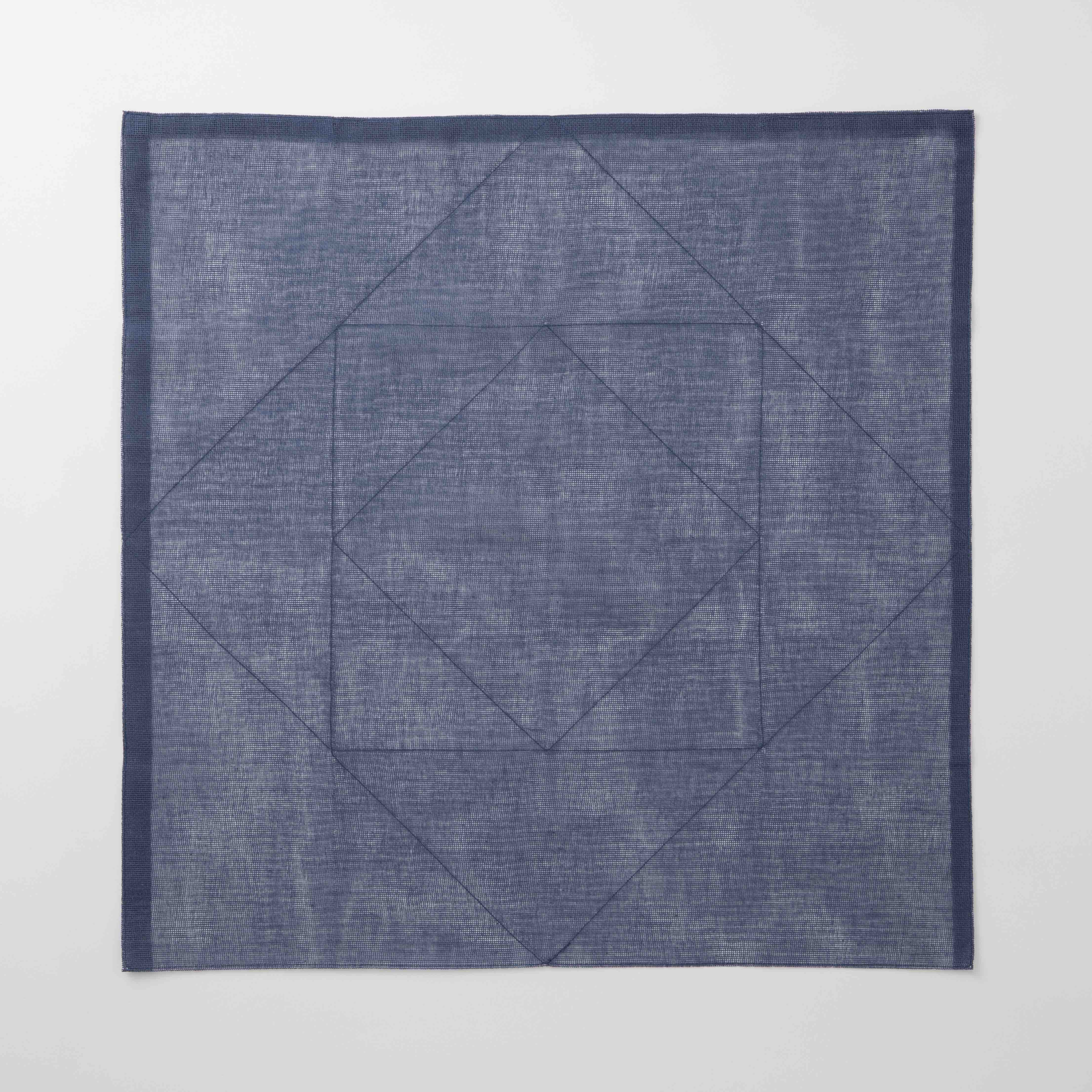 Blue textured square tea towel on a white background
