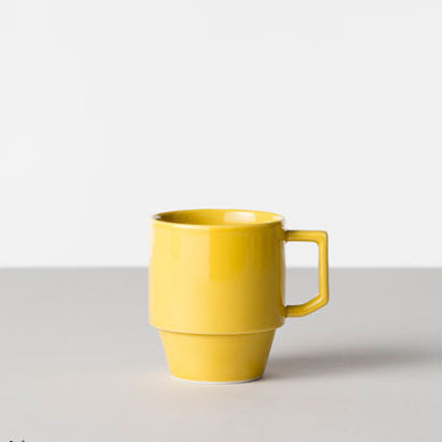 Yellow mug on a light gray background