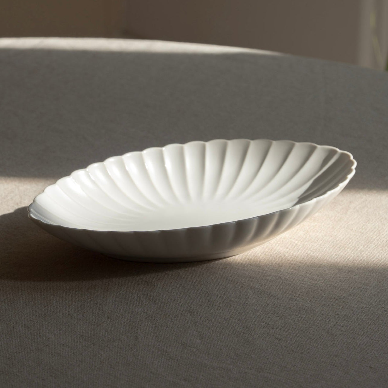 White ceramic plate on a gray surface with a blurred background