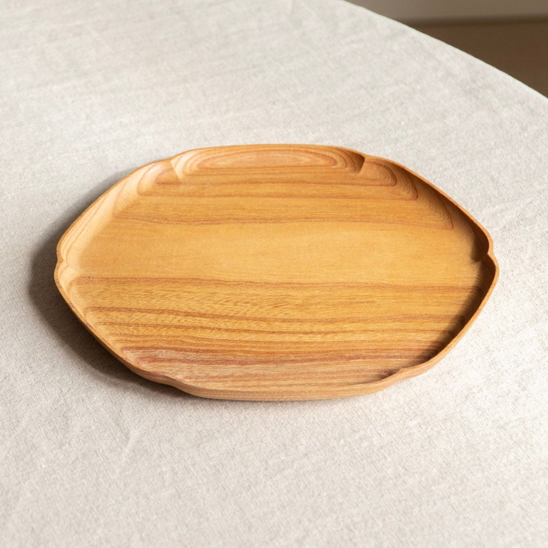 Wooden tray on a textured white surface