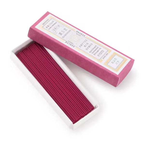 Incense sticks in a pink box on a white background