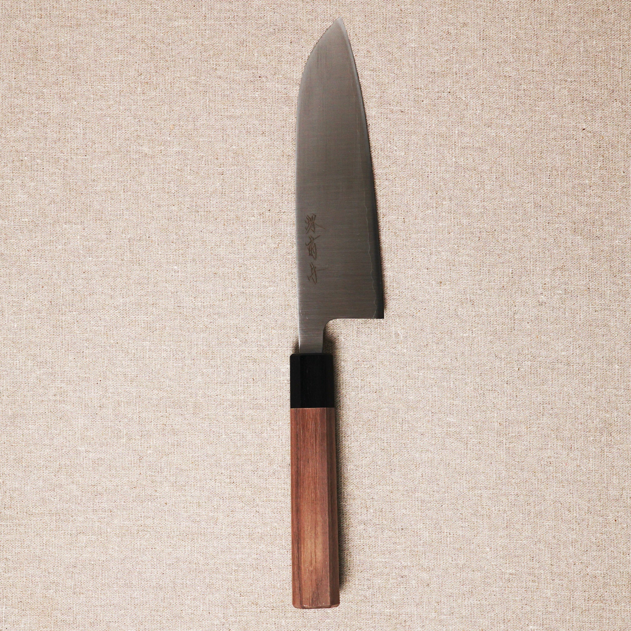 Knife with a wooden handle on a beige textured background