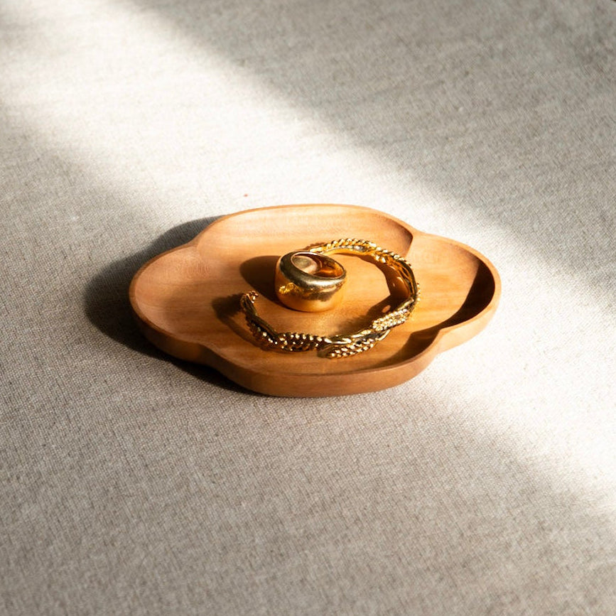 Gold ring on a textured white surface with soft lighting