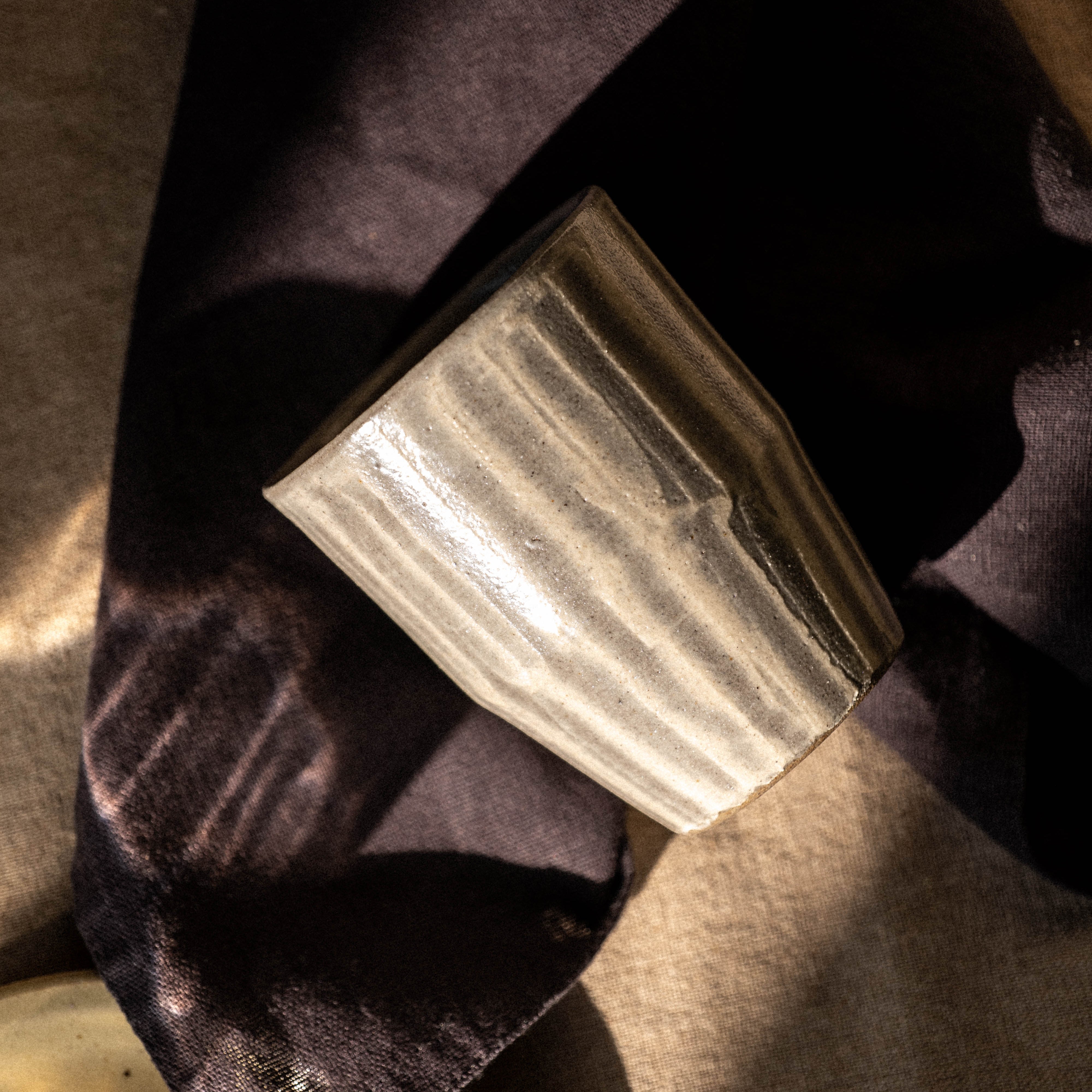 Grey tea cup with white hand striped pattern