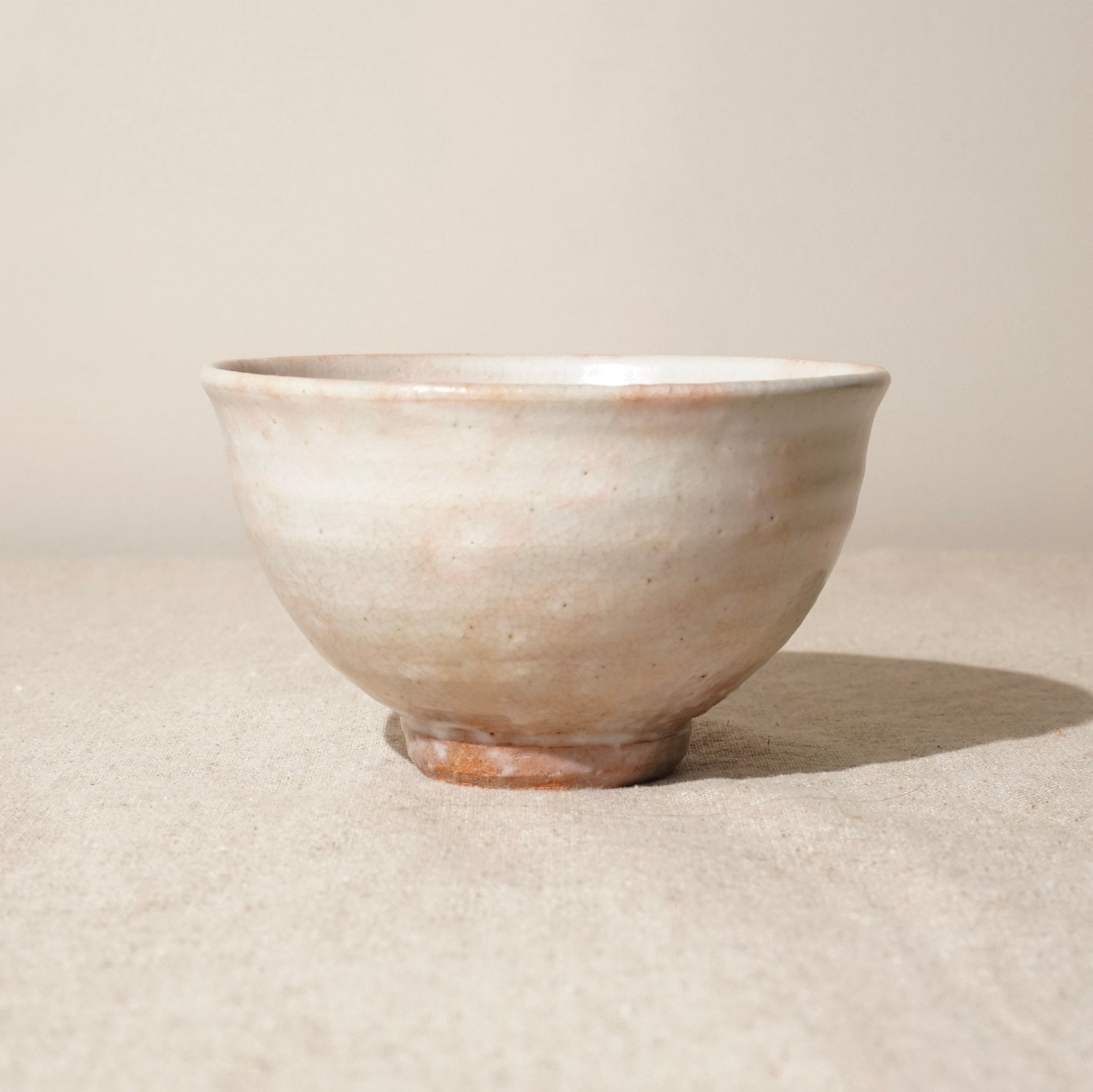 Ceramic matcha bowl on a beige background