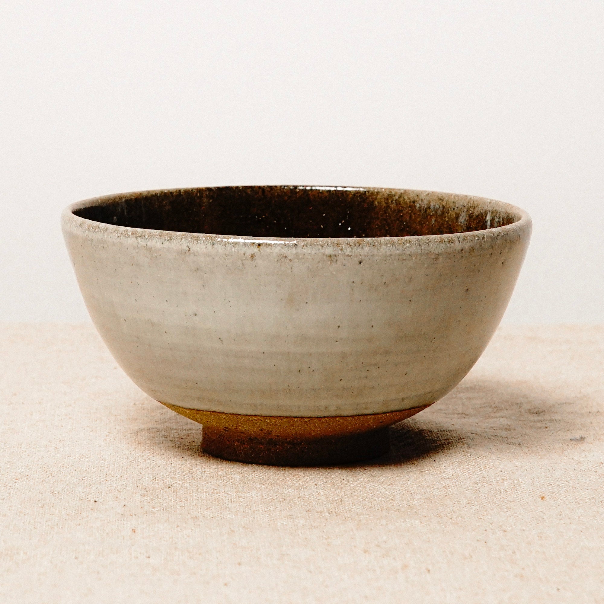 Ceramic bowl with a textured surface on a beige background