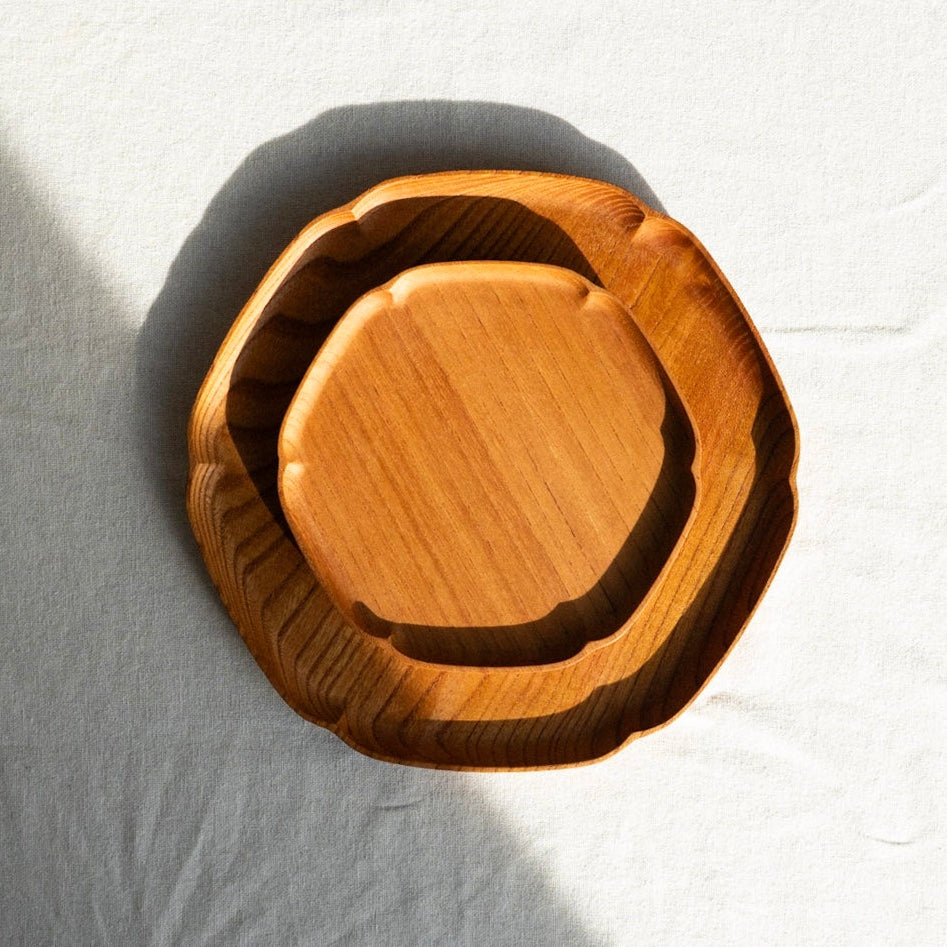 Wooden cutting board on a white surface with a blurred background
