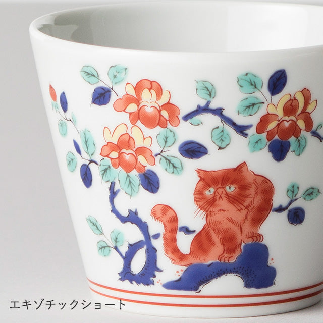 Ceramic cup with a red cat and floral design on a white background