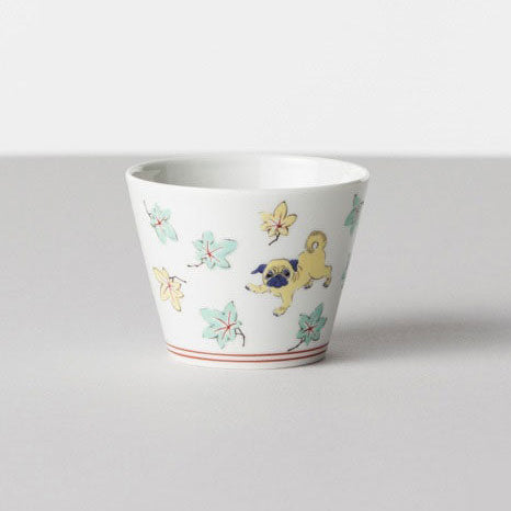 White ceramic cup with colorful animal illustrations on a light gray background
