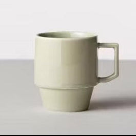 Green ceramic mug on a white background
