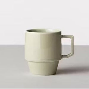 Green ceramic mug on a white background