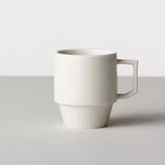White ceramic mug on a light gray background