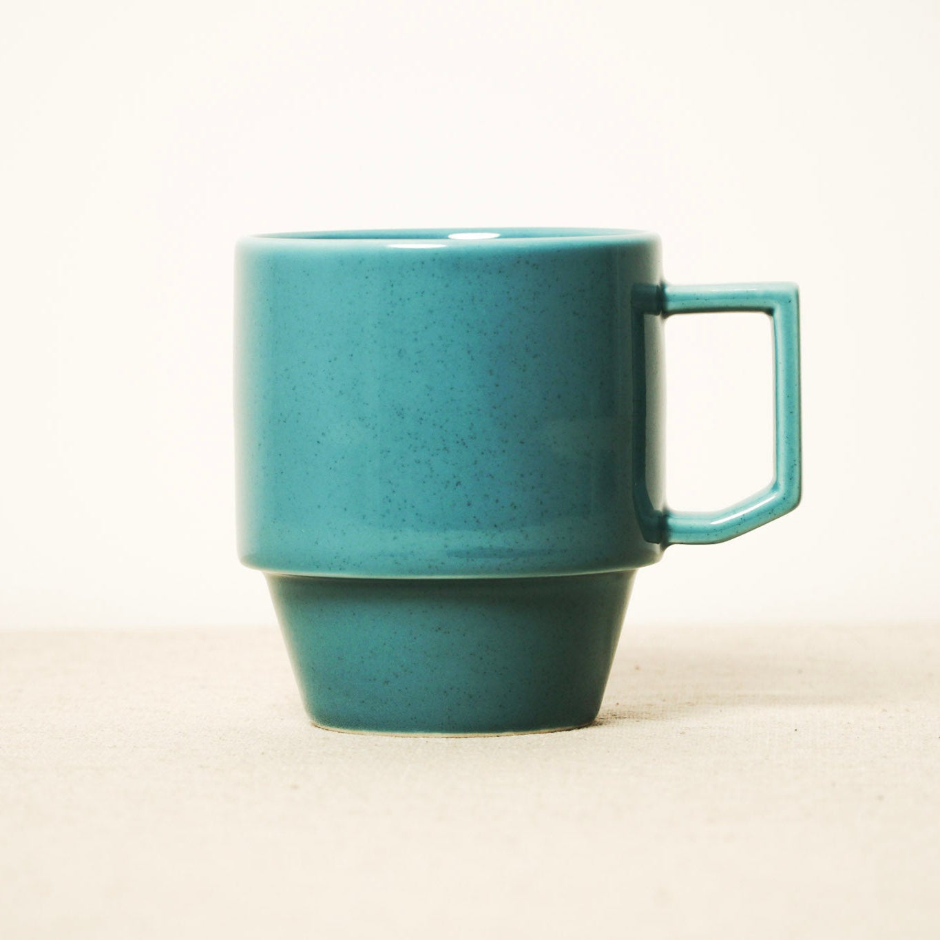 Turquoise ceramic mug on a white background
