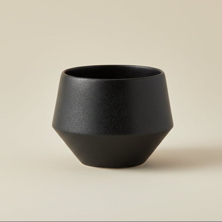 Black ceramic vase on a white background