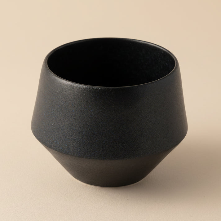 Black ceramic cup on a white background