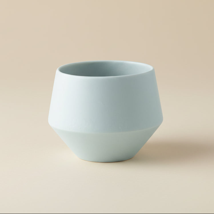 Light blue ceramic planter on a white background