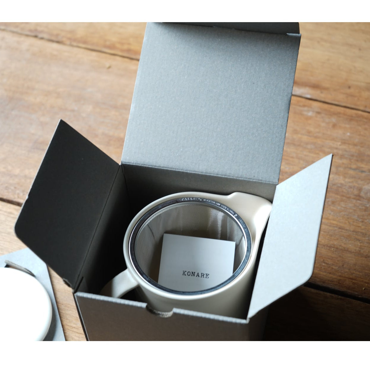 Coffee filter in a branded box on a wooden surface