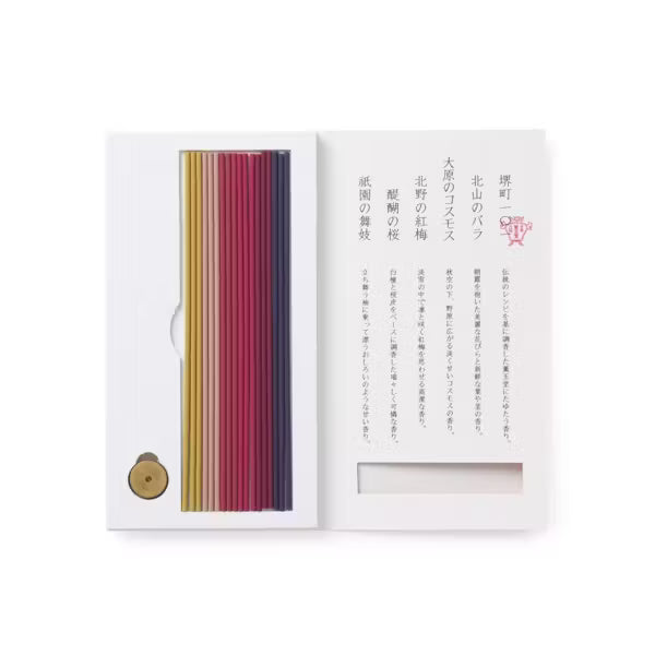 Set of colored incense sticks in a white box with text on a white background