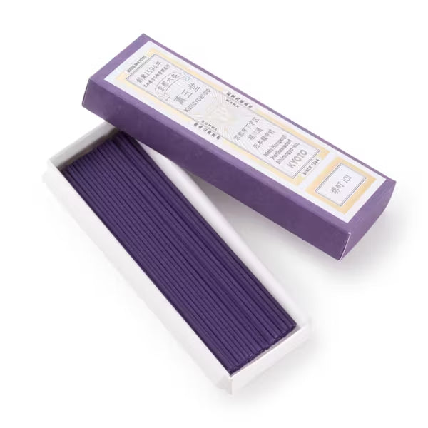 Purple incense stick box with incense sticks inside on a white background