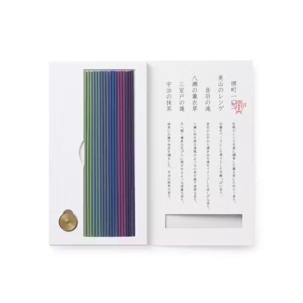 Set of colored incense sticks in a white box with text on a white background