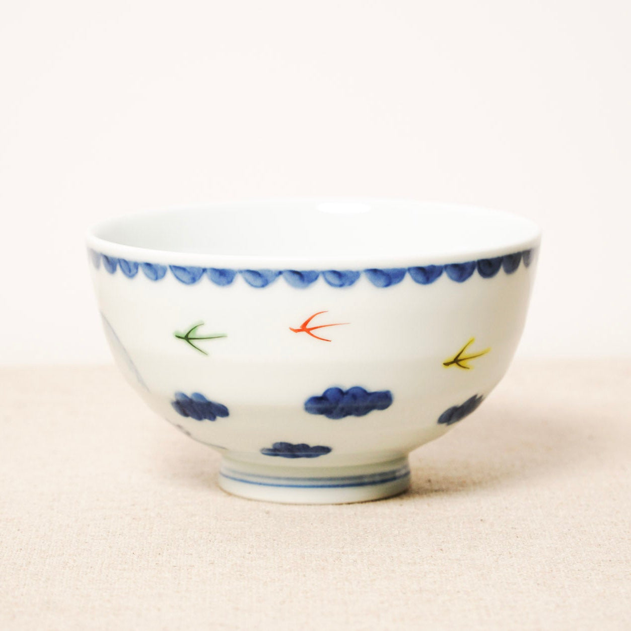 Ceramic bowl with colorful designs on a white background
