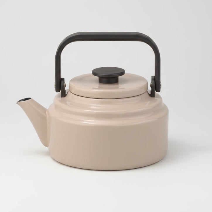 Noda Horo kettle in beige, with black handle and lid on a white background