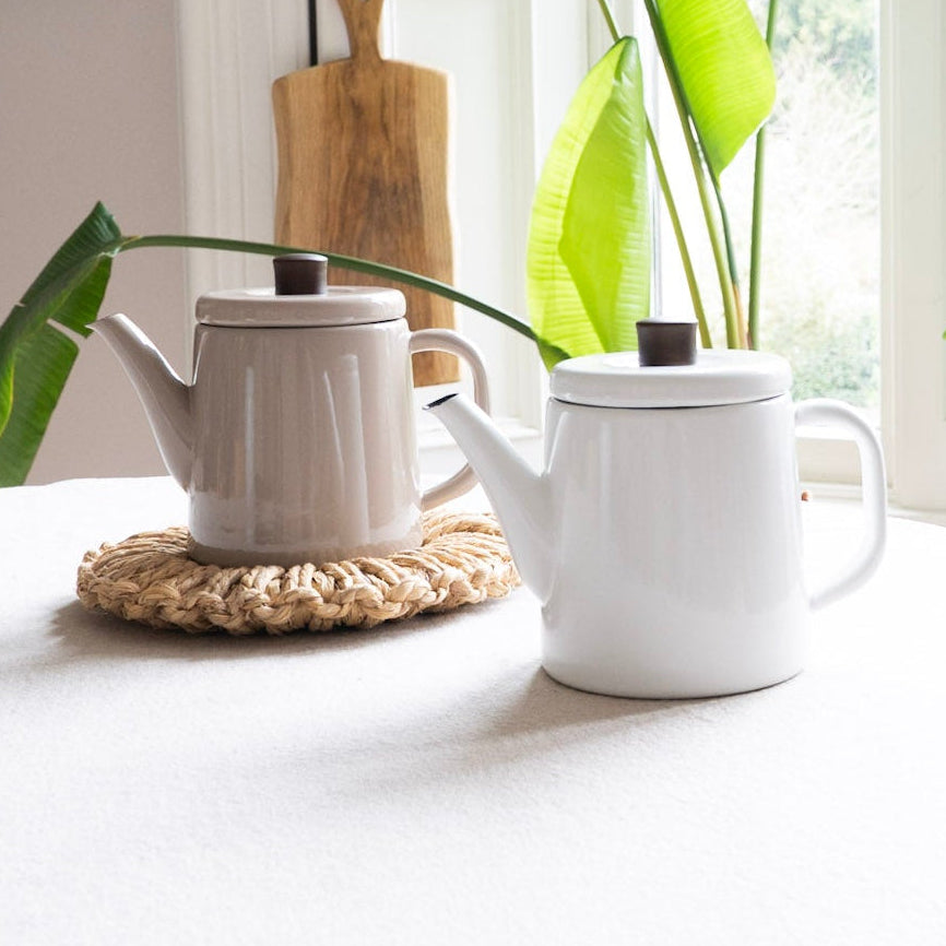 Tea set on a table with plants in the background