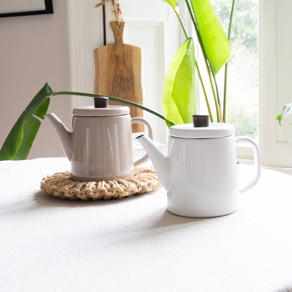 Tea set on a table with plants in the background