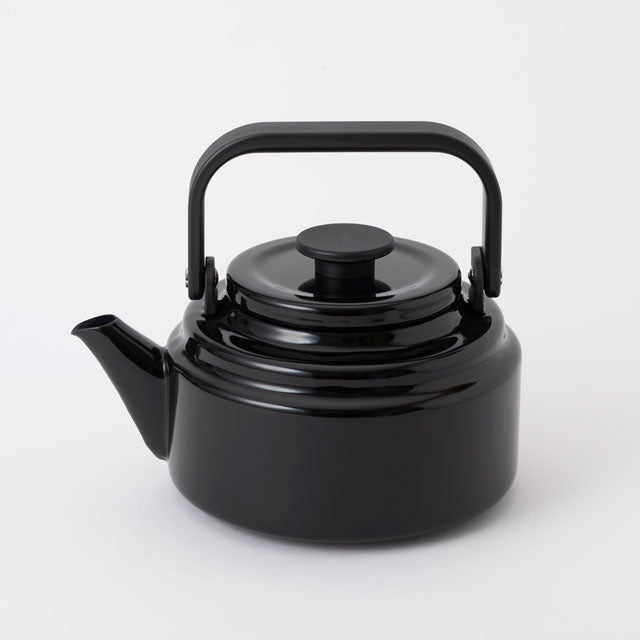 green enamel kettle with black handle