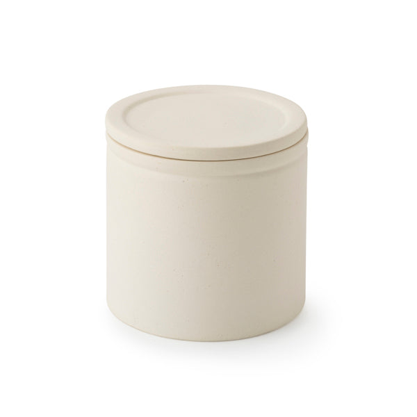 Beige ceramic jar with lid on a white background