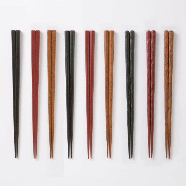 Set of wooden chopsticks in various colors on a white background