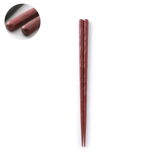 Pair of red wooden chopsticks on a white background